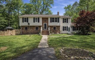 Richmond VA home with price-reduced real estate sign in 2026 housing market